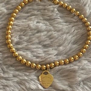 Tiffany & Co. gold heart charm bracelet.